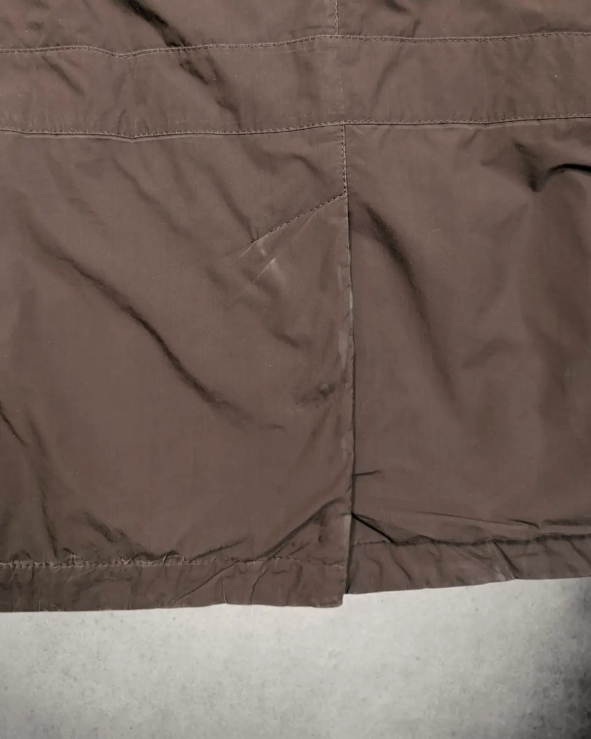 Seitenschlitz einer braunen al Zileri Herrenjacke mit gebrauchsspuren 