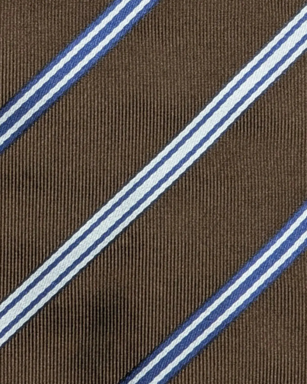 Detailaufnahme einer luxuriösen Seidenkrawatte von Corneliani in braun mit weiß/blauen Streifenmuster